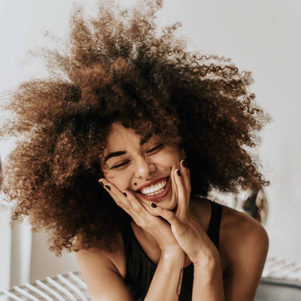 Black woman with a huge smile on her face and her afro hair LARGE ] who does God say I am | Positively Jane  