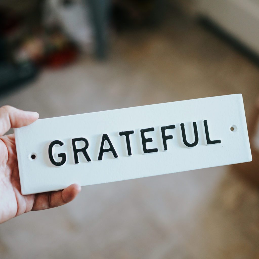 the word grateful on a white tile | gratitude changes attitude | Positively Jane