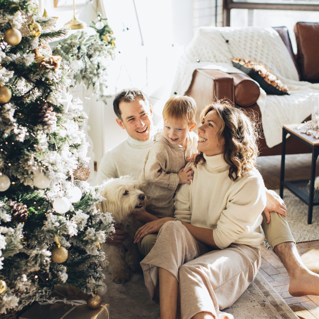 mom, dad and little boy sitting by christmas tree | Peaceful Harmony During the Christmas Season | Positively Jane  