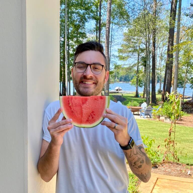 man eating a slice of watermelon