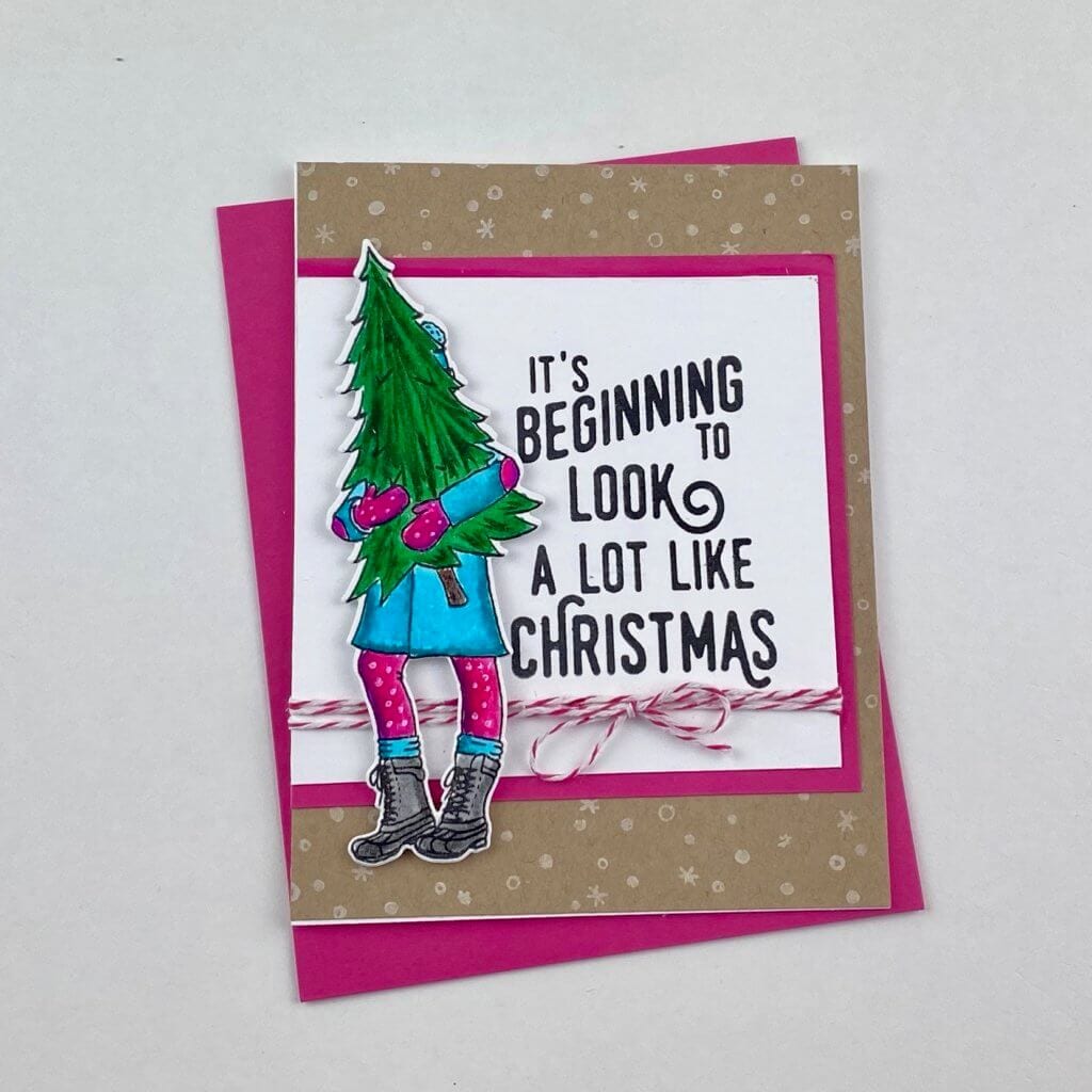 Girl carrying a Christmas tree on a card
