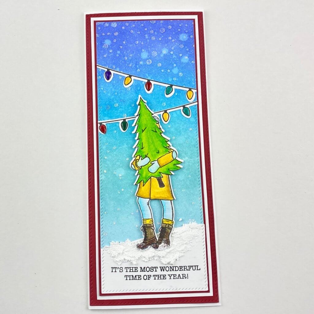 girl holding a christmas tree in a tree yard on a slimline card