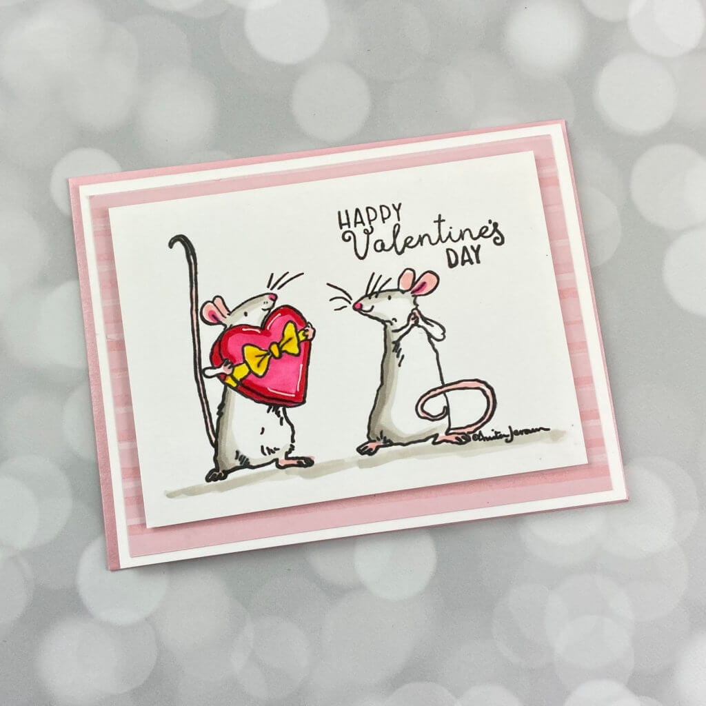 2 mice looking at each other on a valentines day card
