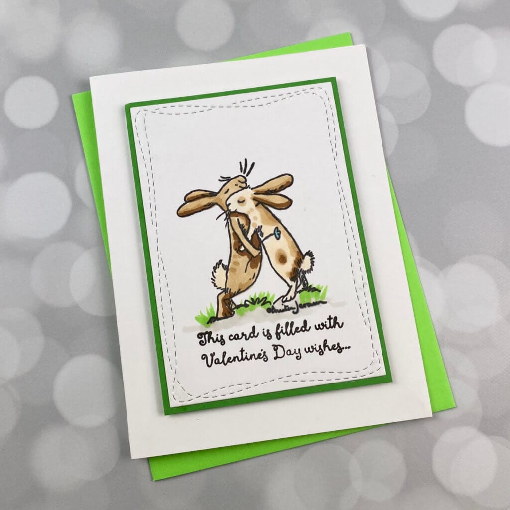 2 bunnies looking at each other on a valentines day card