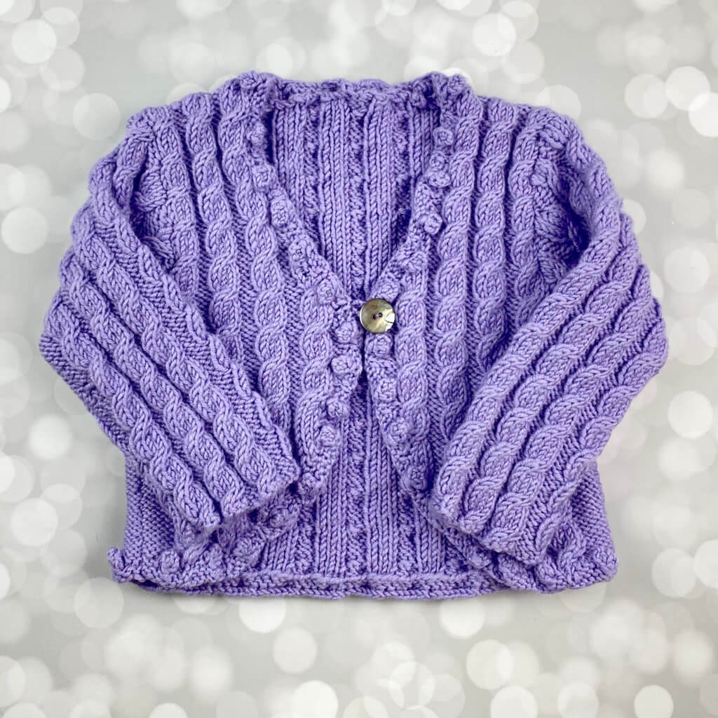 hand knit lavender sweater with lots of cables