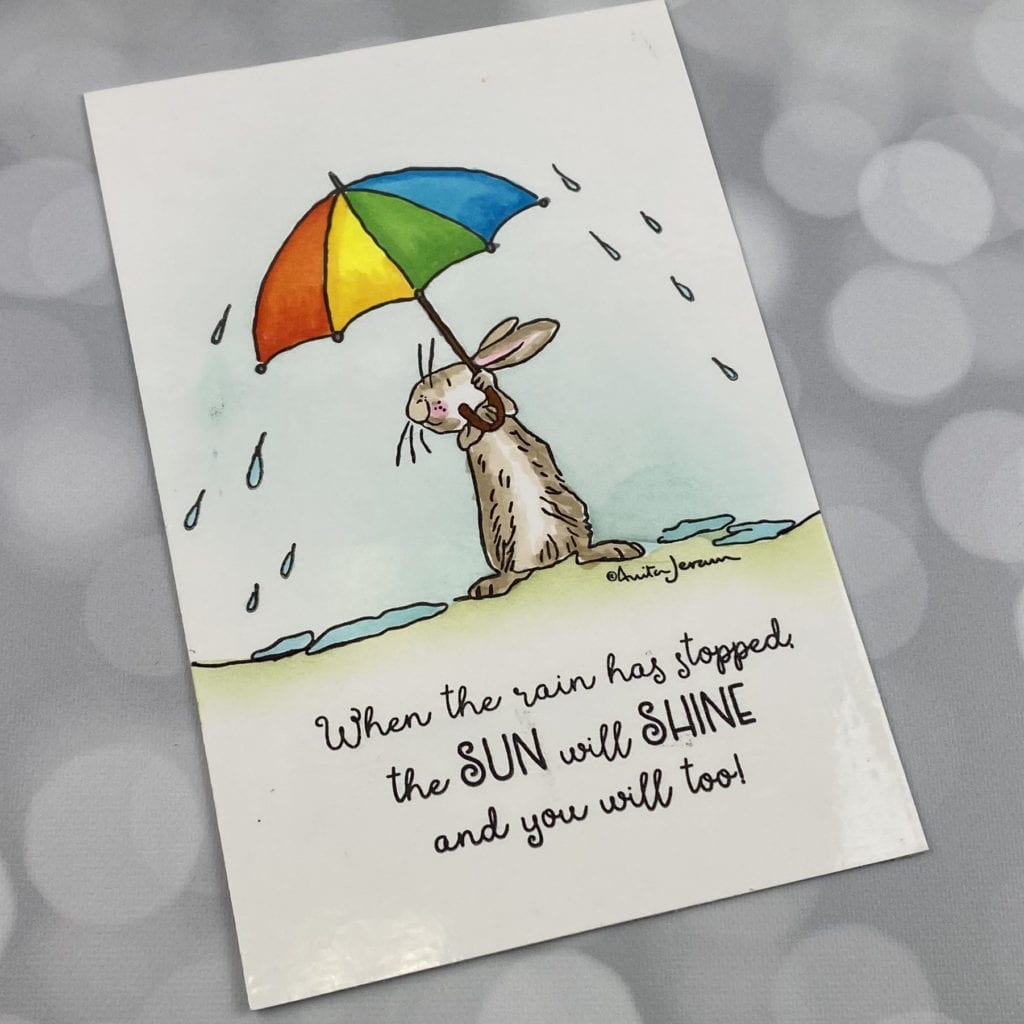 handmade card with rabbit standing under an umbrella
