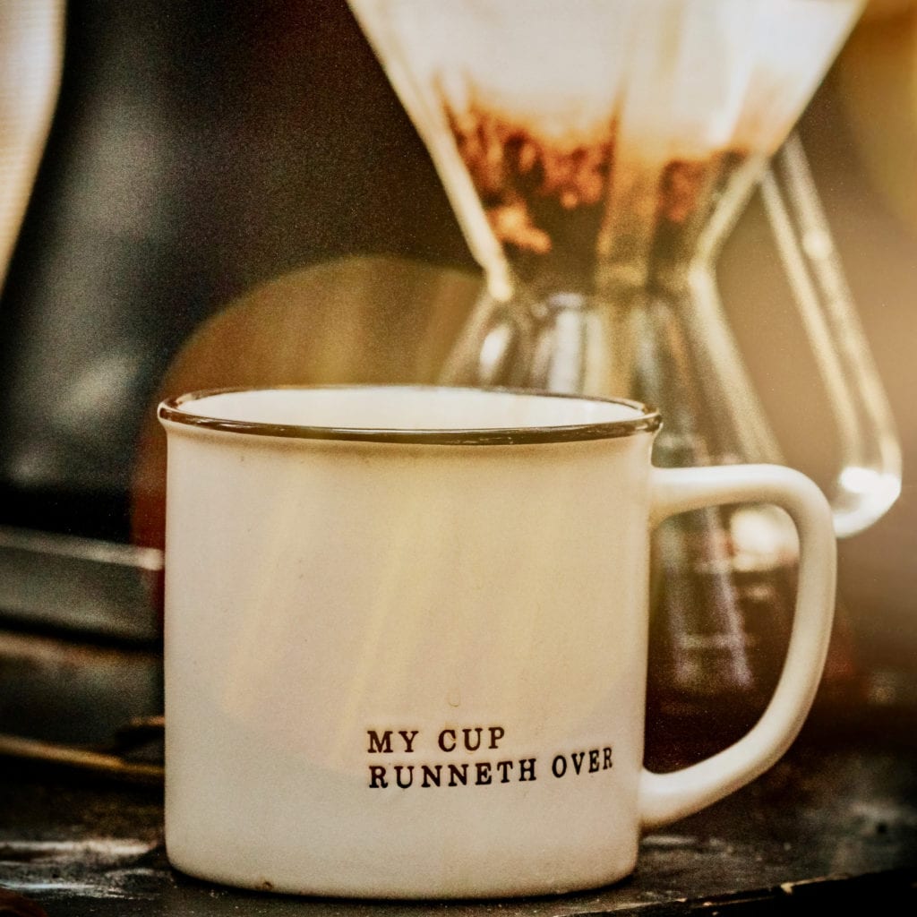 my cup runneth over written on a mug