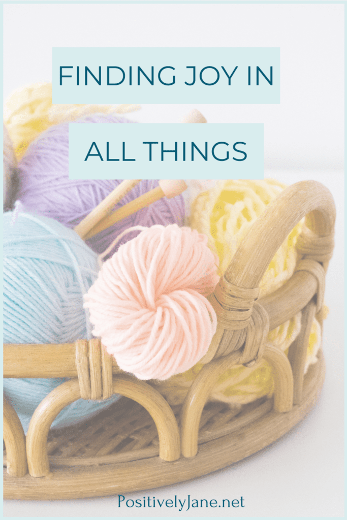 finding joy in all things text over a basket of yarn | Positively Jane