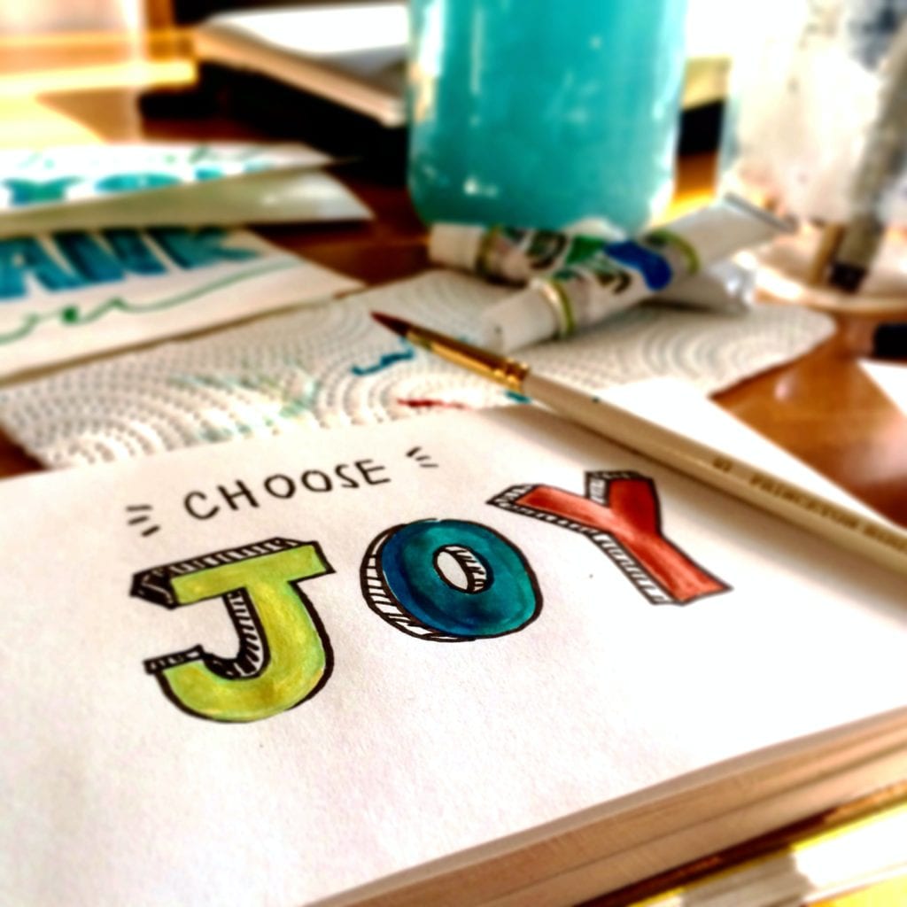 What is Joyful Living - the word joy written in a notebook