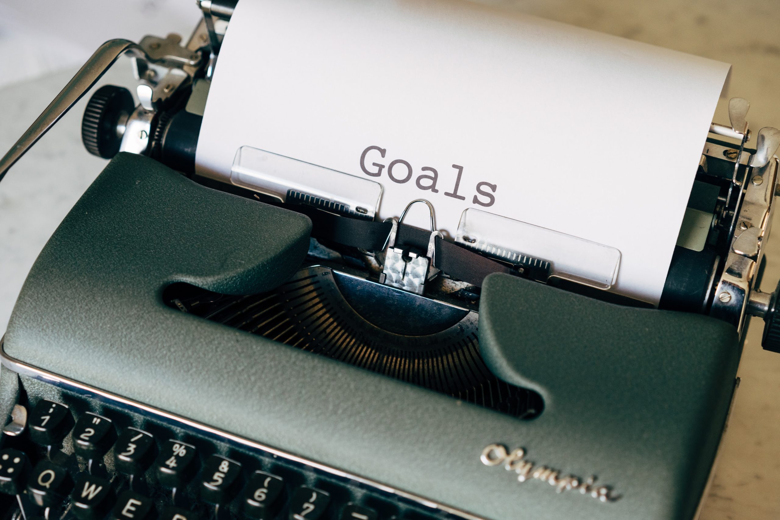 the word goals typed out on a sheet of paper that is inside an old fashioned typewriter