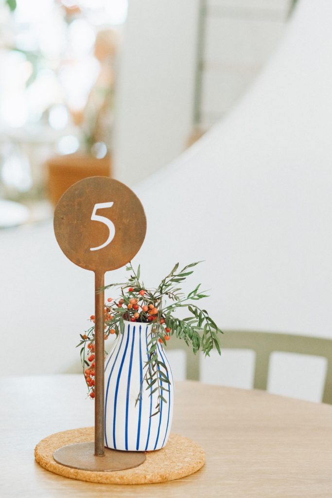 vase with flowers on a table with a stick and the number 5 on top | 5 simple steps to choosing joy | Positively Jane