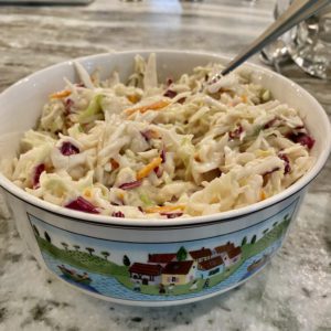 bowl of coleslaw with a spoon in it | chick-fil-a coleslaw recipe | Positively Jane