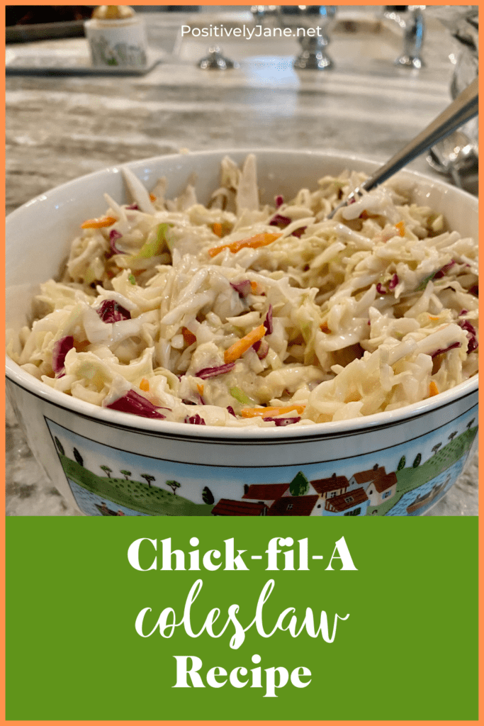 bowl of coleslaw with a spoon in it. Pin for Pinterest. | chick-fil-a coleslaw recipe | Positively Jane