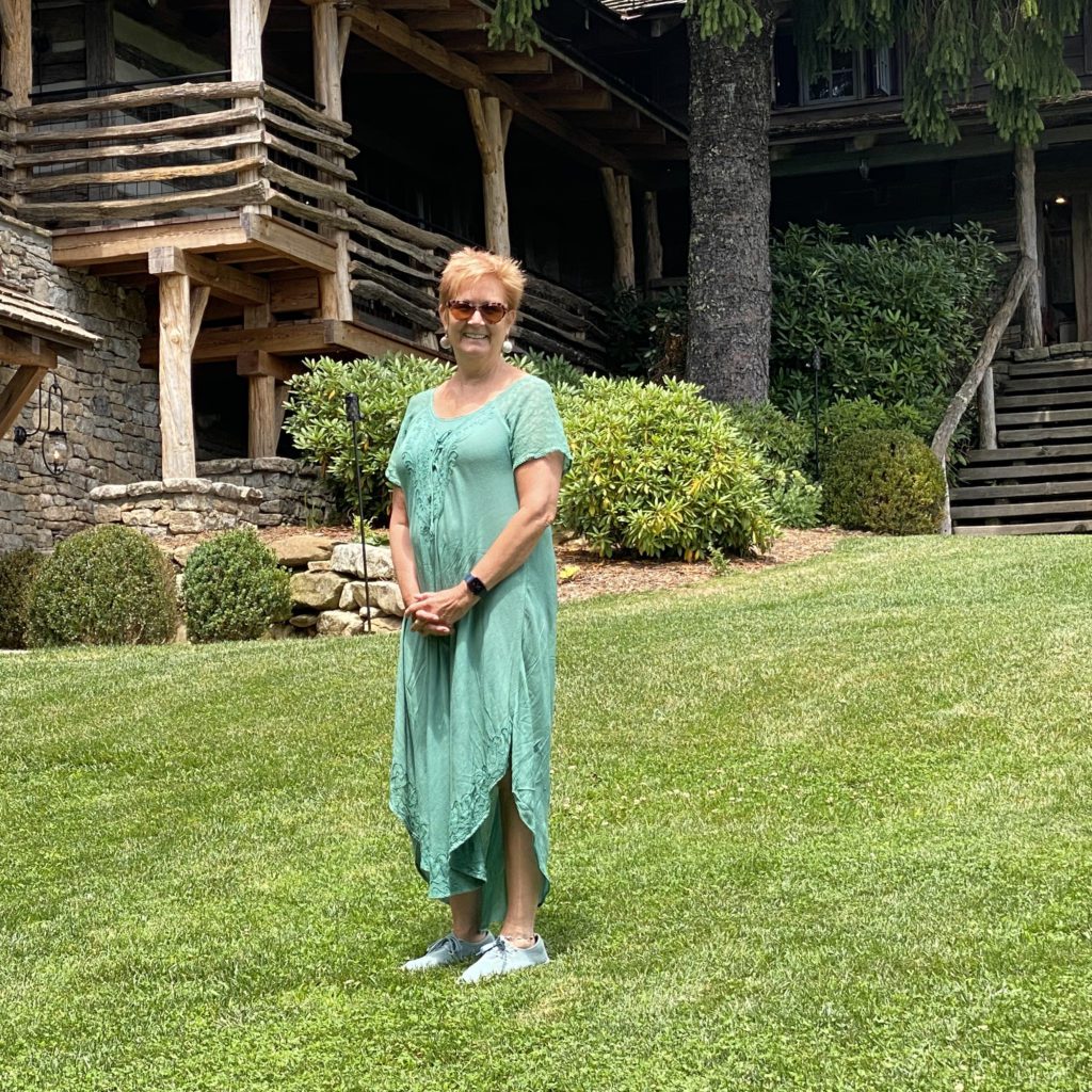 jane standing in front of the swag hotel in a long green dress | the swag | Positively Jane  