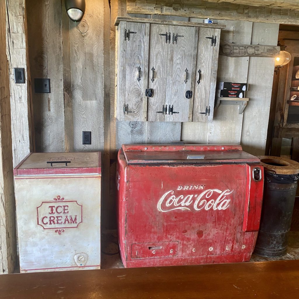 old coca cola cooler on the front porch of the swag hotel | Positively Jane