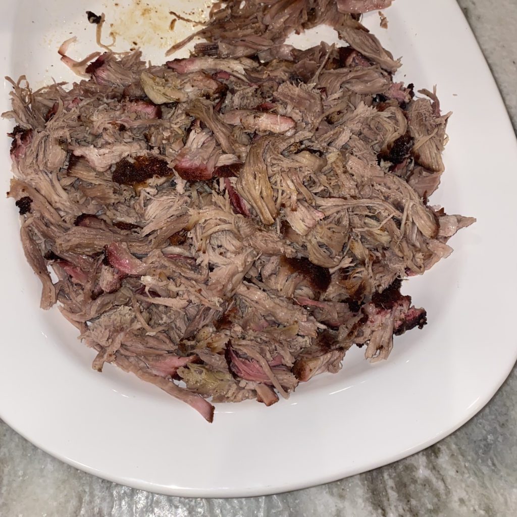smoked pork butt shredded and on a plate | smoked pork butt recipe | Positively Jane