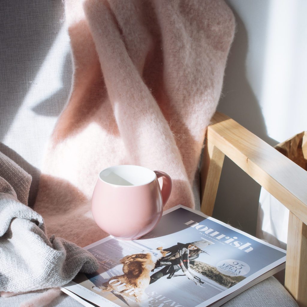 tray with a mug of coffee, magazine and a pink blanket next to it  | what is contentment in life | Positively Jane