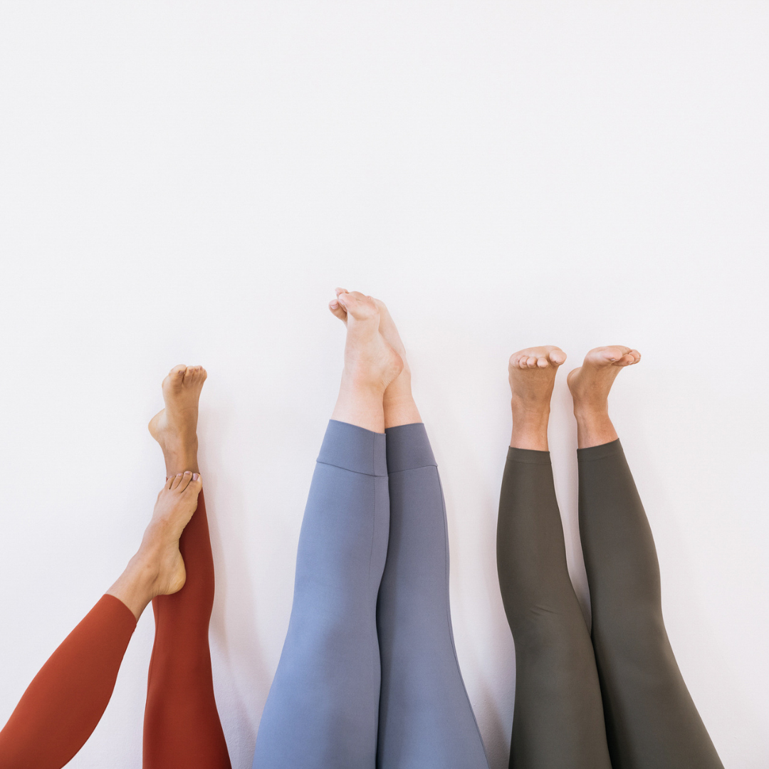 3 pair of legs wearing different colored leggings laying on a floor | positively jane | Cant' vs won't