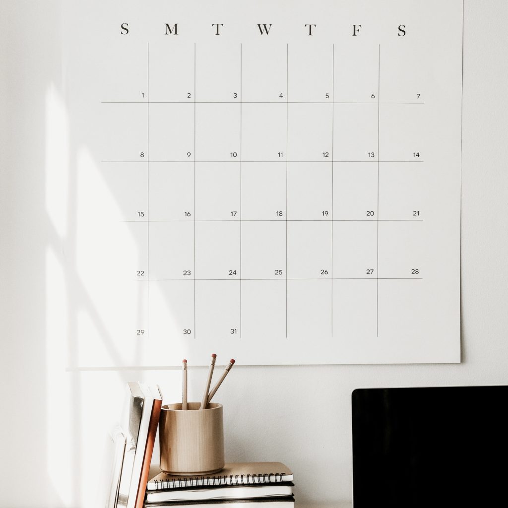 large white calendar on a wall above a desk | what I learned in 3 years as a blogger | positively Jane